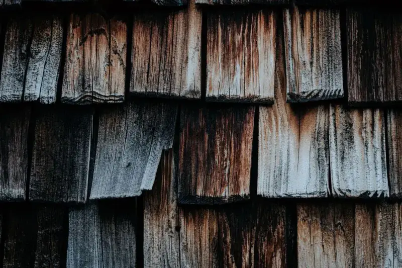 Close-up of old weathered wooden roof shakes showing age and wear
